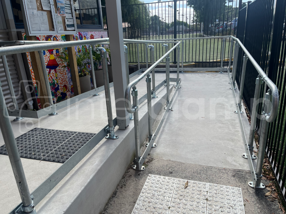 Key clamp disability compliant handrail with toeboard installed at a school